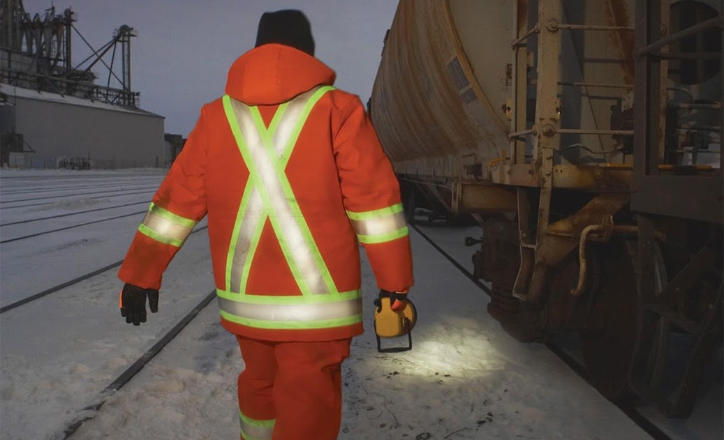 Man with flashlight and hi vis gear