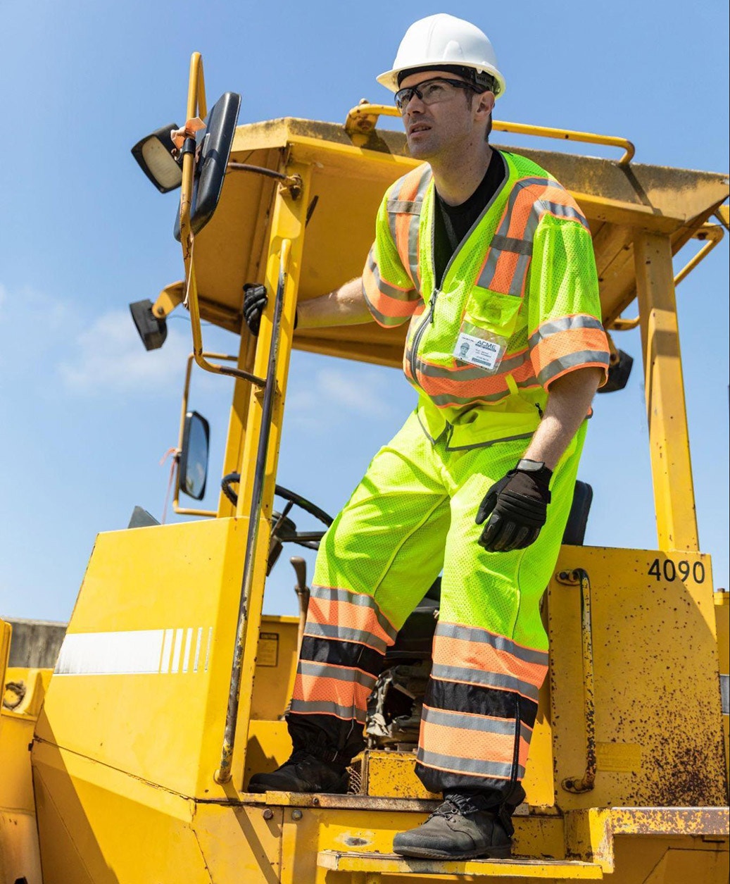 man looking out from heavy machinery